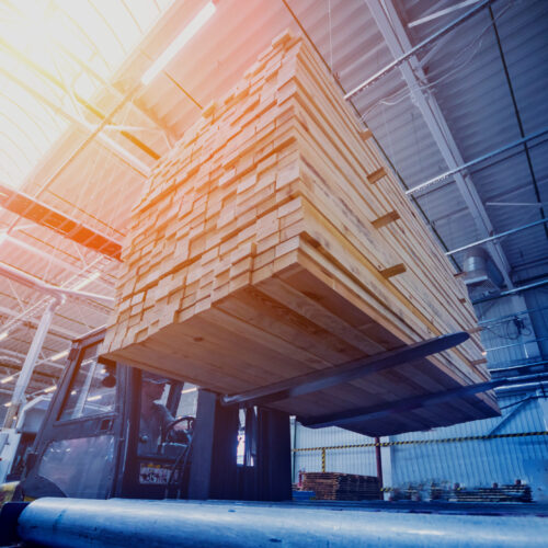 Stack of natural rough wooden boards. Wooden boards, lumber, industrial wood. Industrial timber